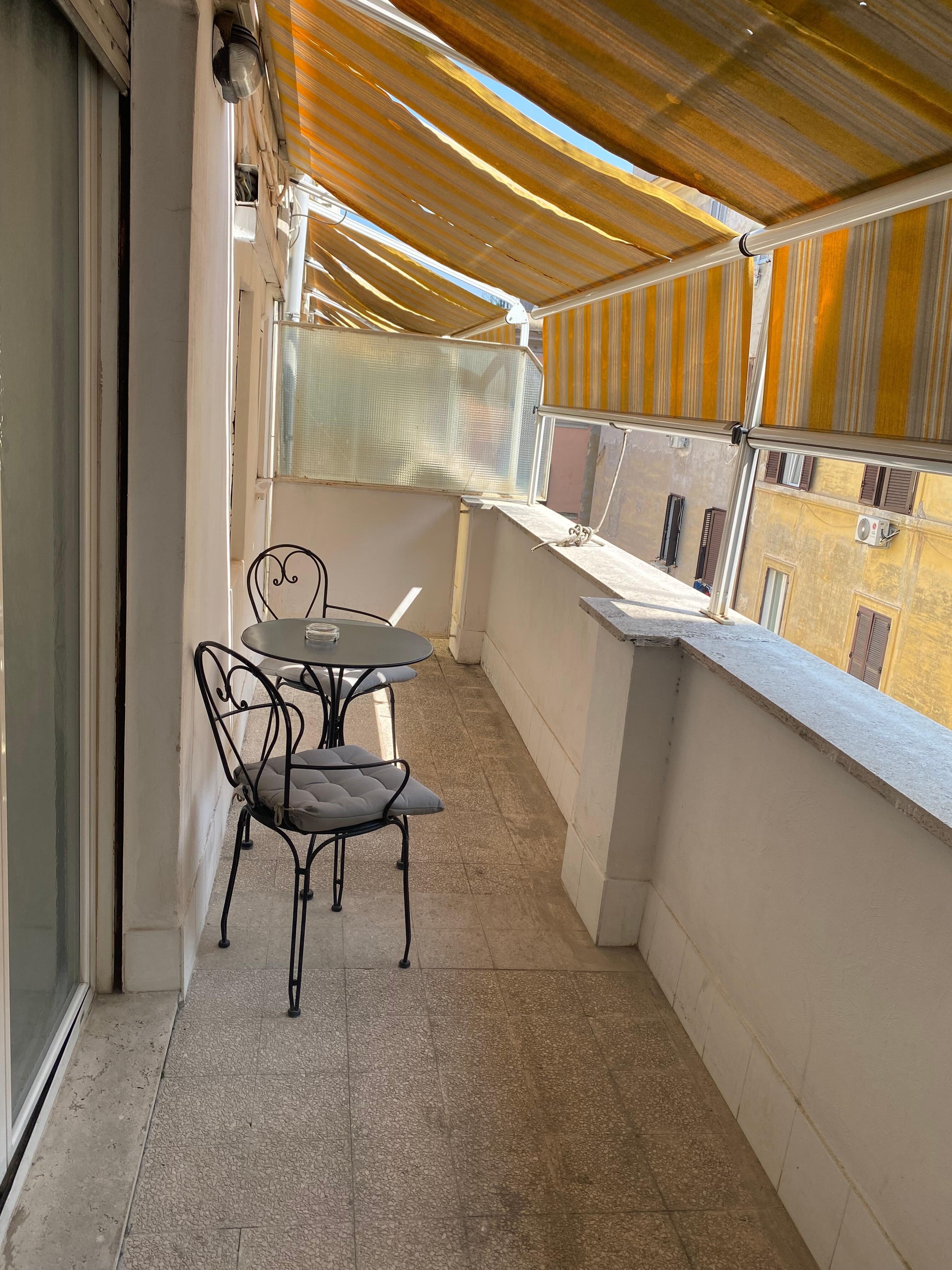 Good size balcony with 2 chairs and a table