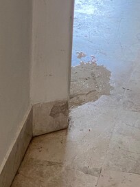 Beginning of leak from wall onto the floor. It grew in size every day.