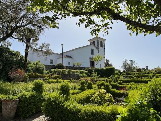 View from the garden, looking back at the church and museum with an interesting collection of artifacts from as early as the stone age to present-day embroidery with chestnut peel. Most original!