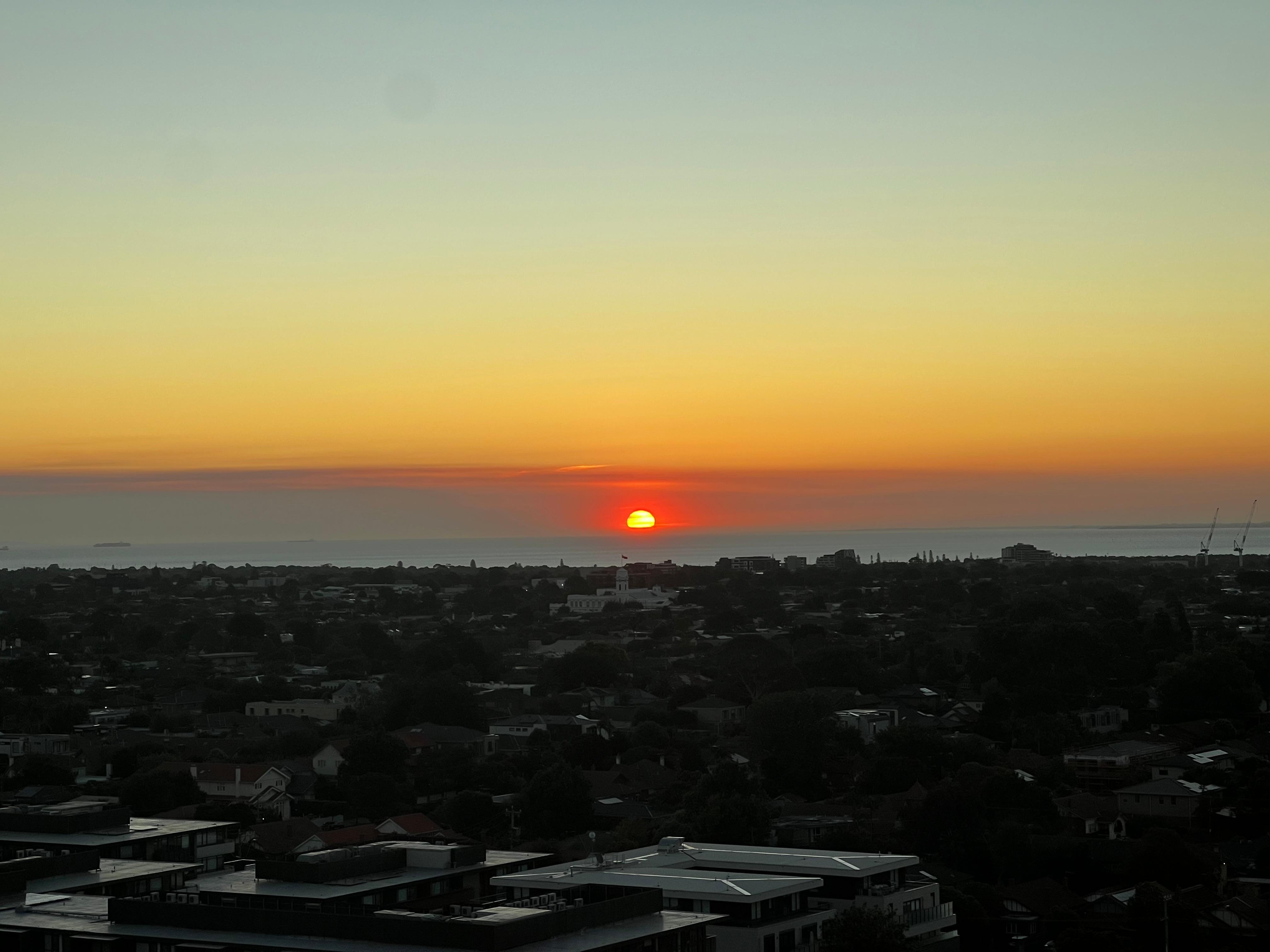 View of Sun setting over bay from room