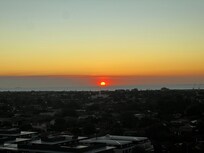 View of Sun setting over bay from room
