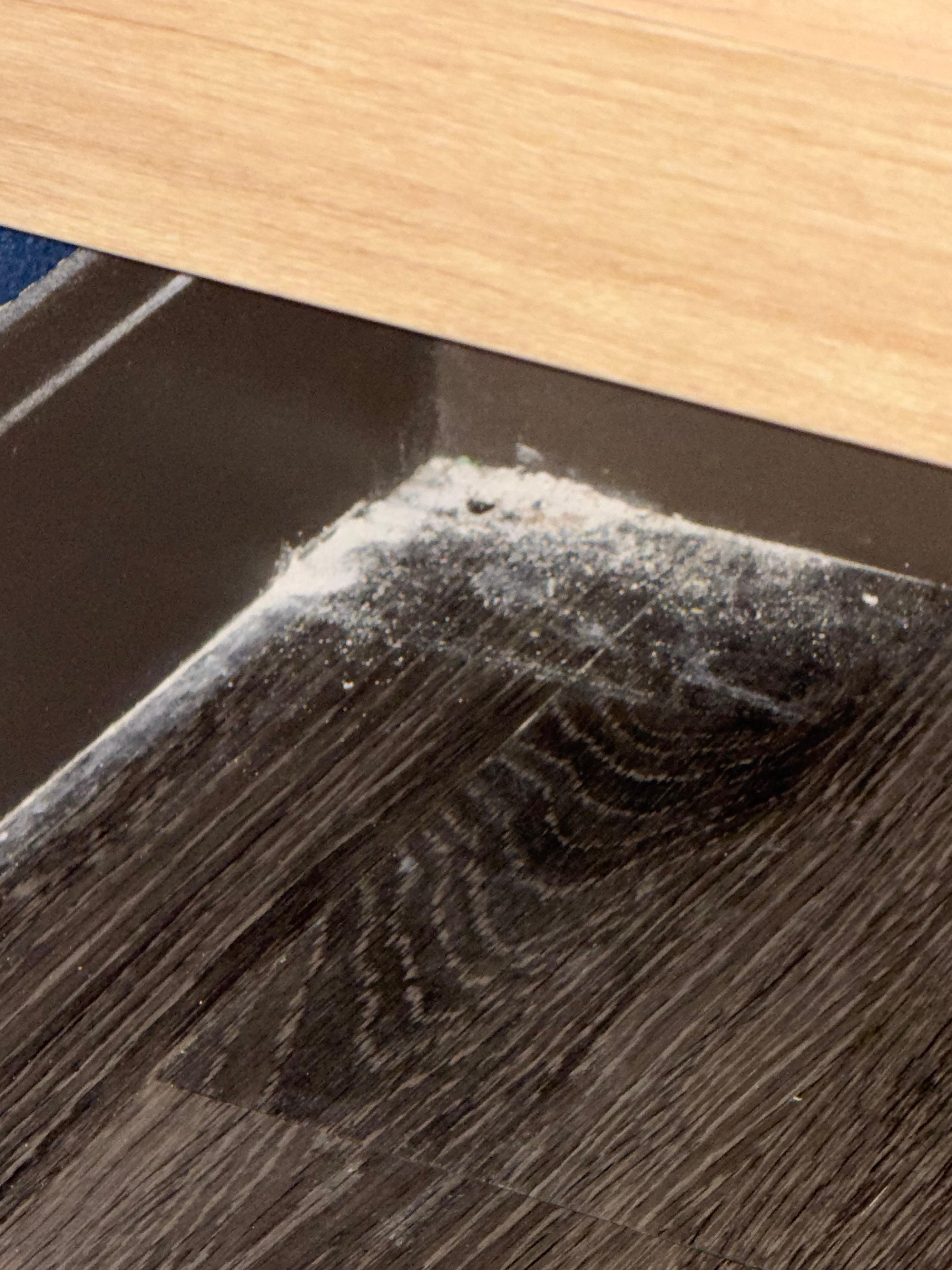 Debris under the sink in the bathroom.