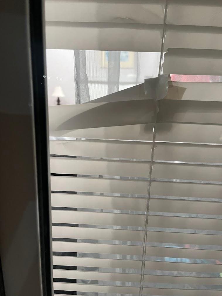 Looking into our room from the shared balcony through the gap in the blinds.