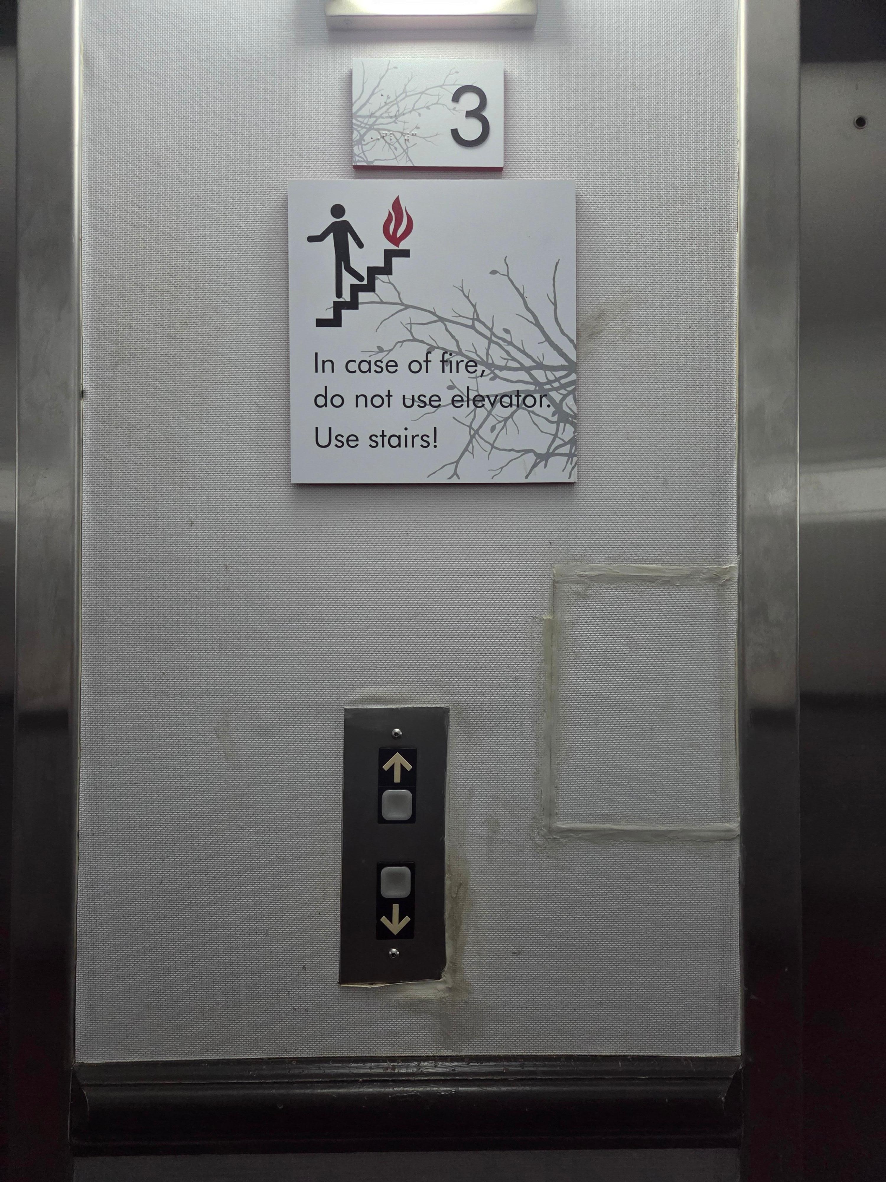 The wall next to the elevator on the third floor. Dirty, old, in need of care.