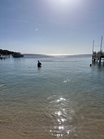 Calm clear water in the bay in front of the Beach House