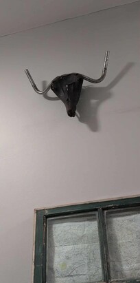 Wall decoration made from bicycle seat and handlebars