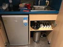 Open a closet and find a small fridge/freezer, kettle, cutlery and garbage can. No ice tray and the property does not provide access to ice