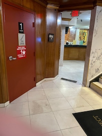Check in desk at bottom of entrance stairs