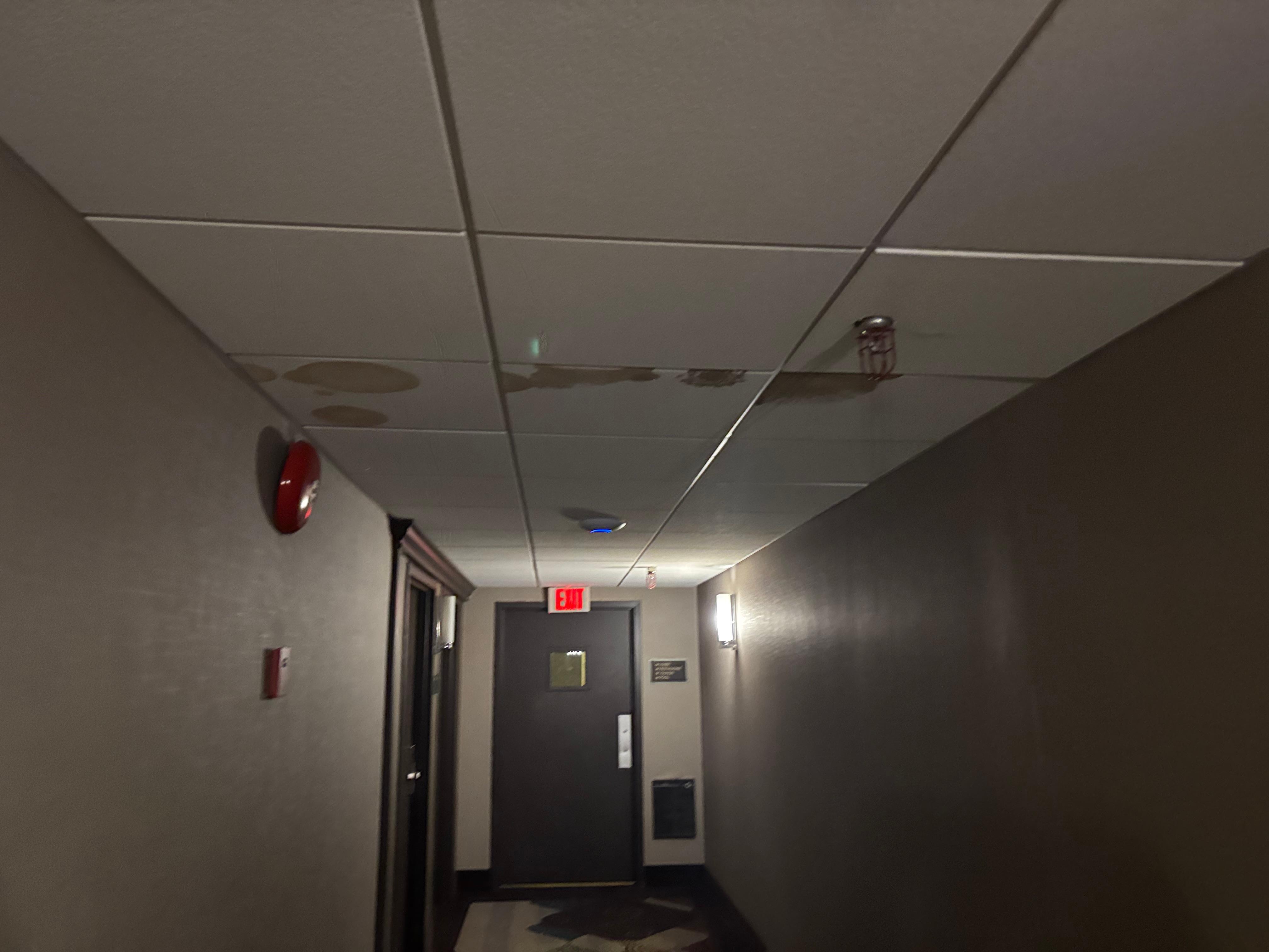 Hallways are very dark and bad stains on the ceiling.