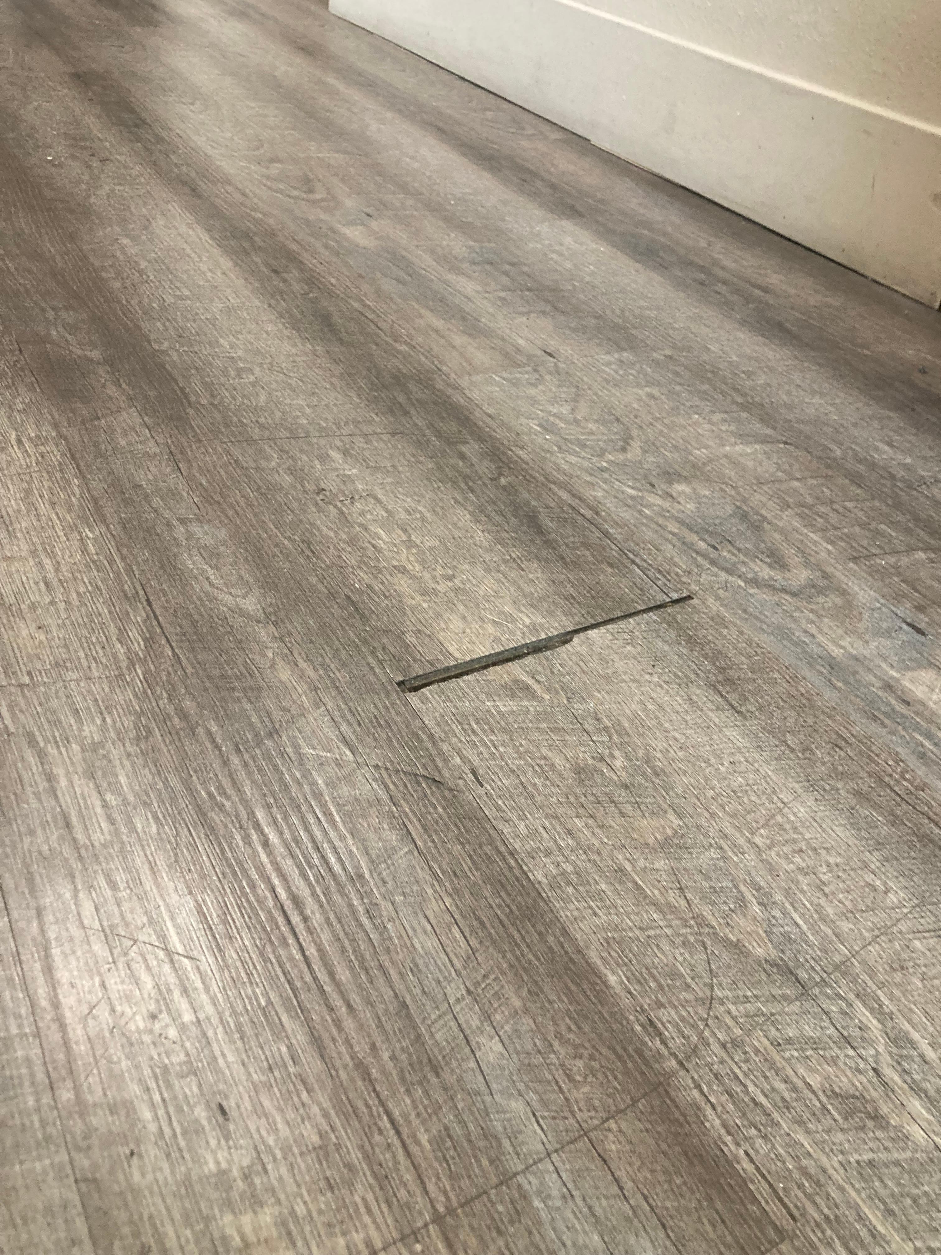 Scratched and gapped plastic floor