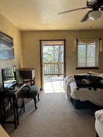 First room down the hallway; all doors open to the deck.