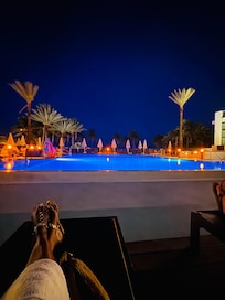 Beautiful lighting around the pools at night.