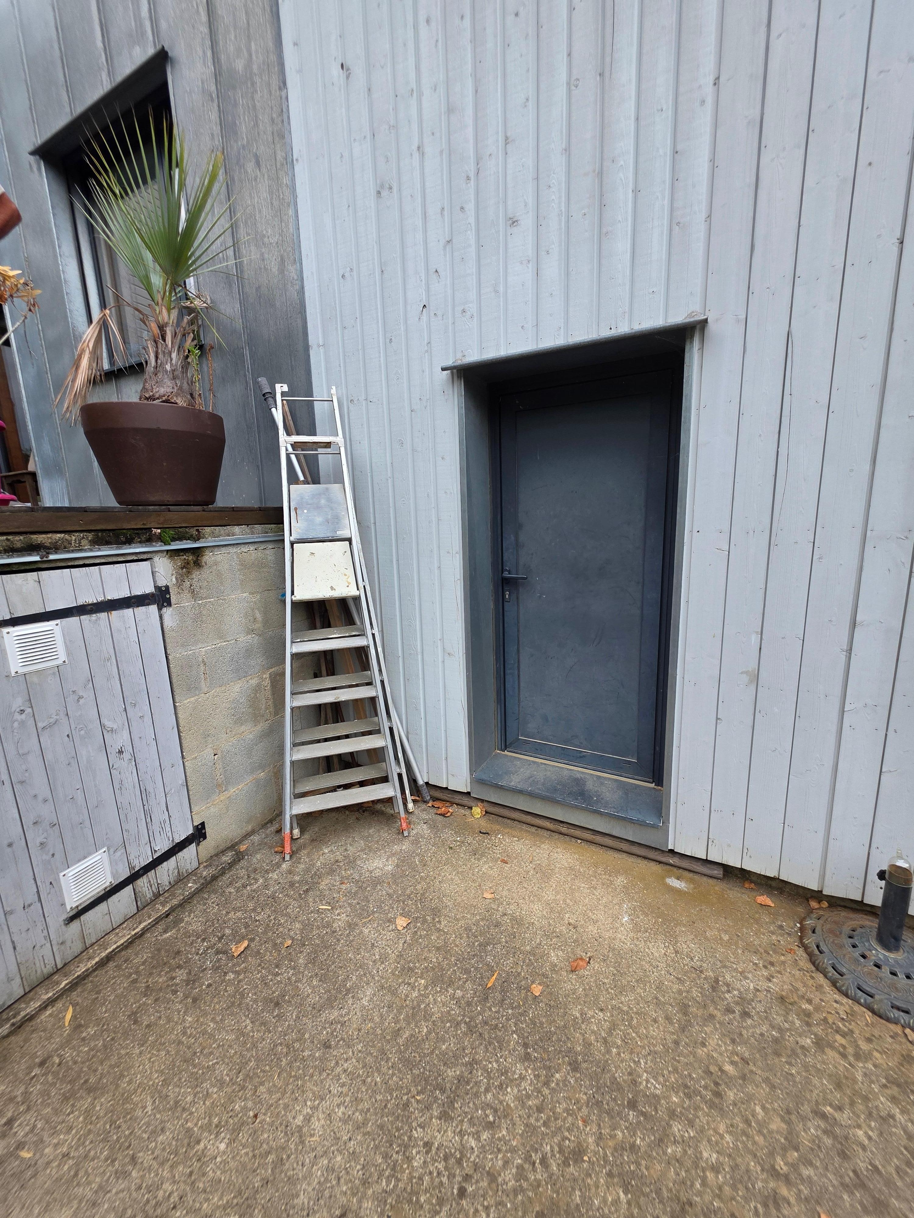 Unfenced drop from side of pool to driveway. Ladders lying around, not stored correctly