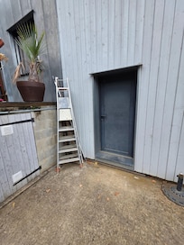 Unfenced drop from side of pool to driveway. Ladders lying around, not stored correctly