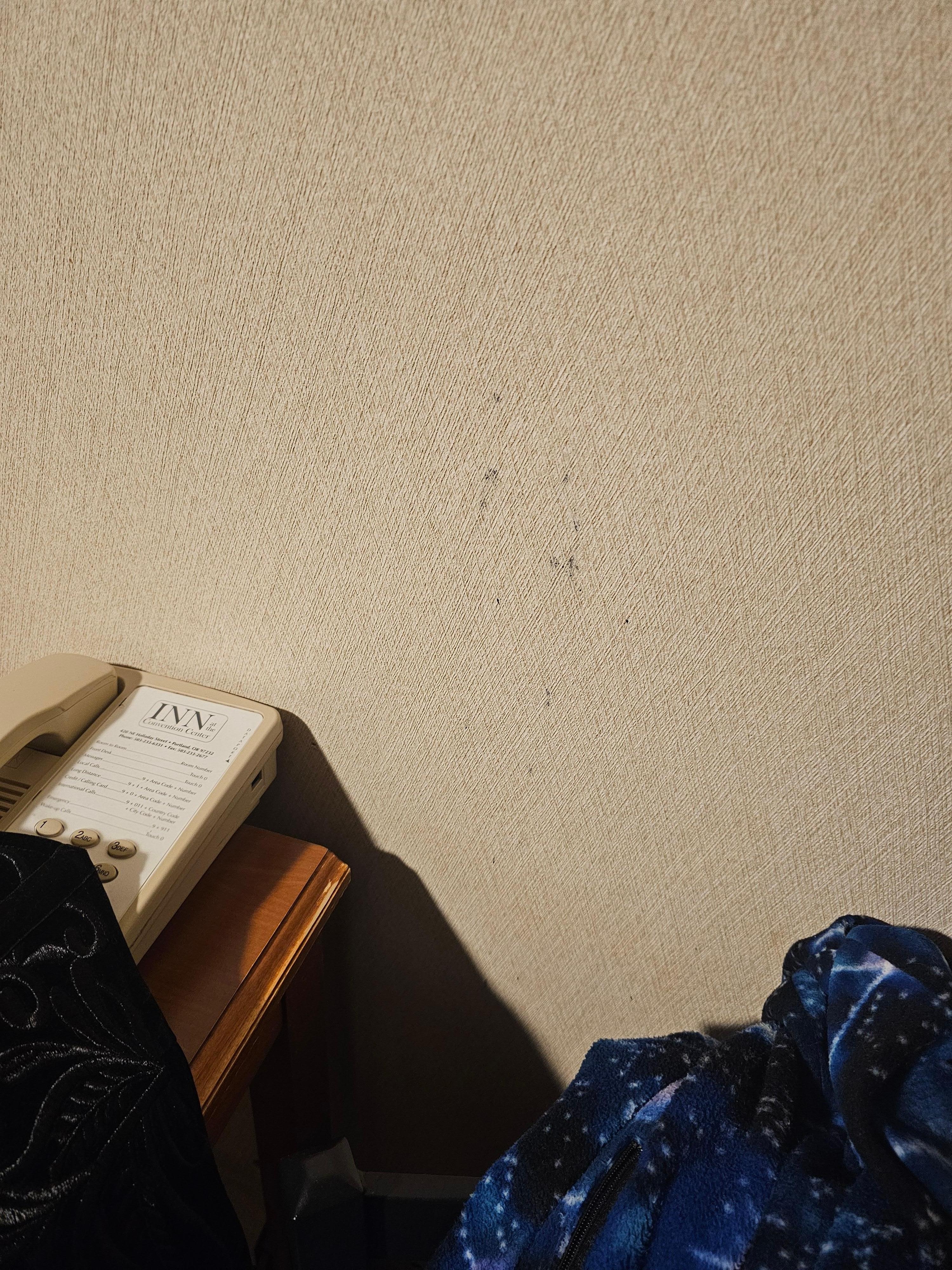 Wall stains by the head of the bed