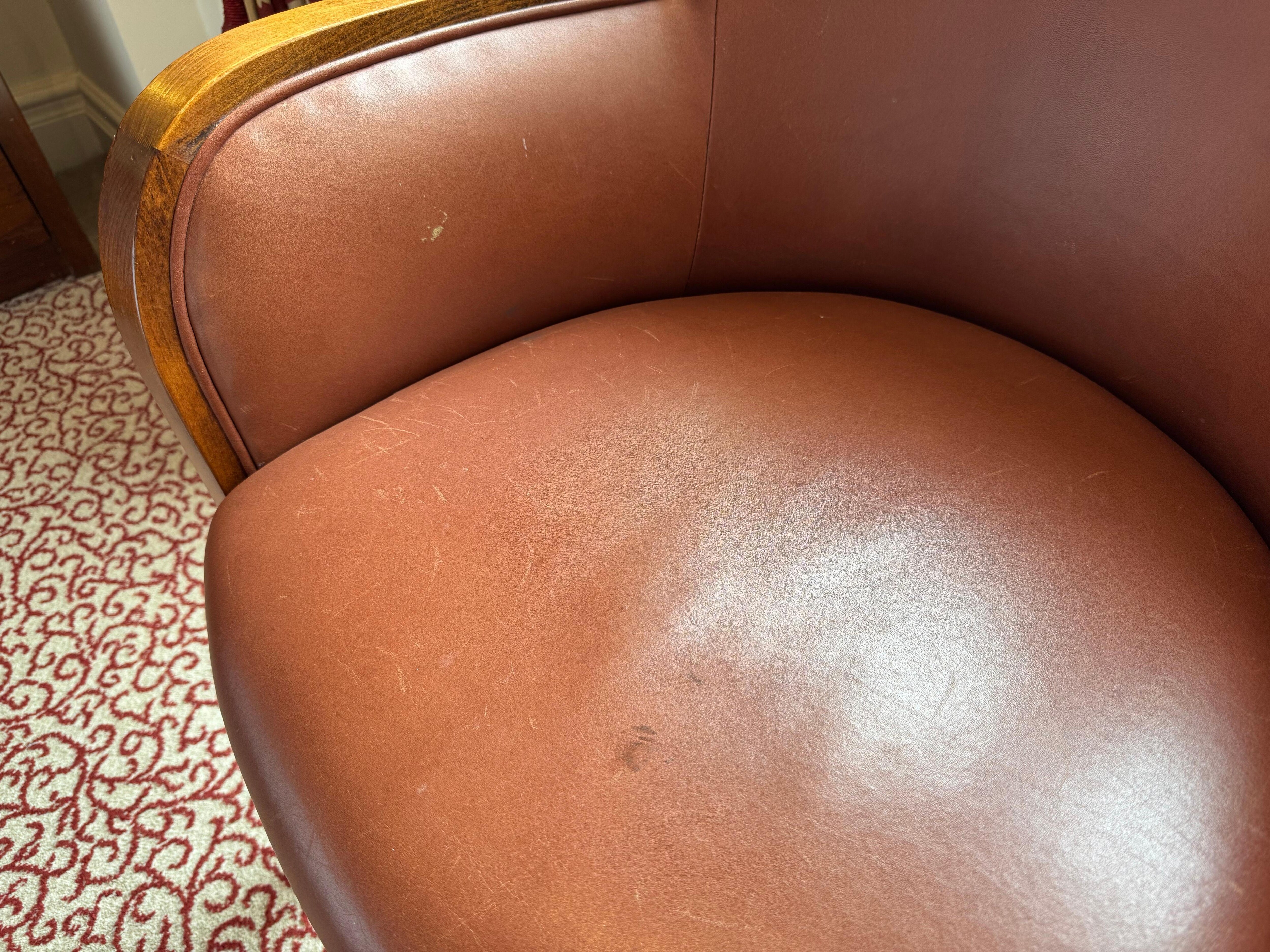 Armchair with visible wear and scuff marks on leather