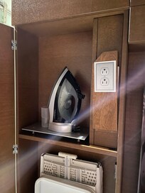 Ironing cupboard with the outlet flap closed