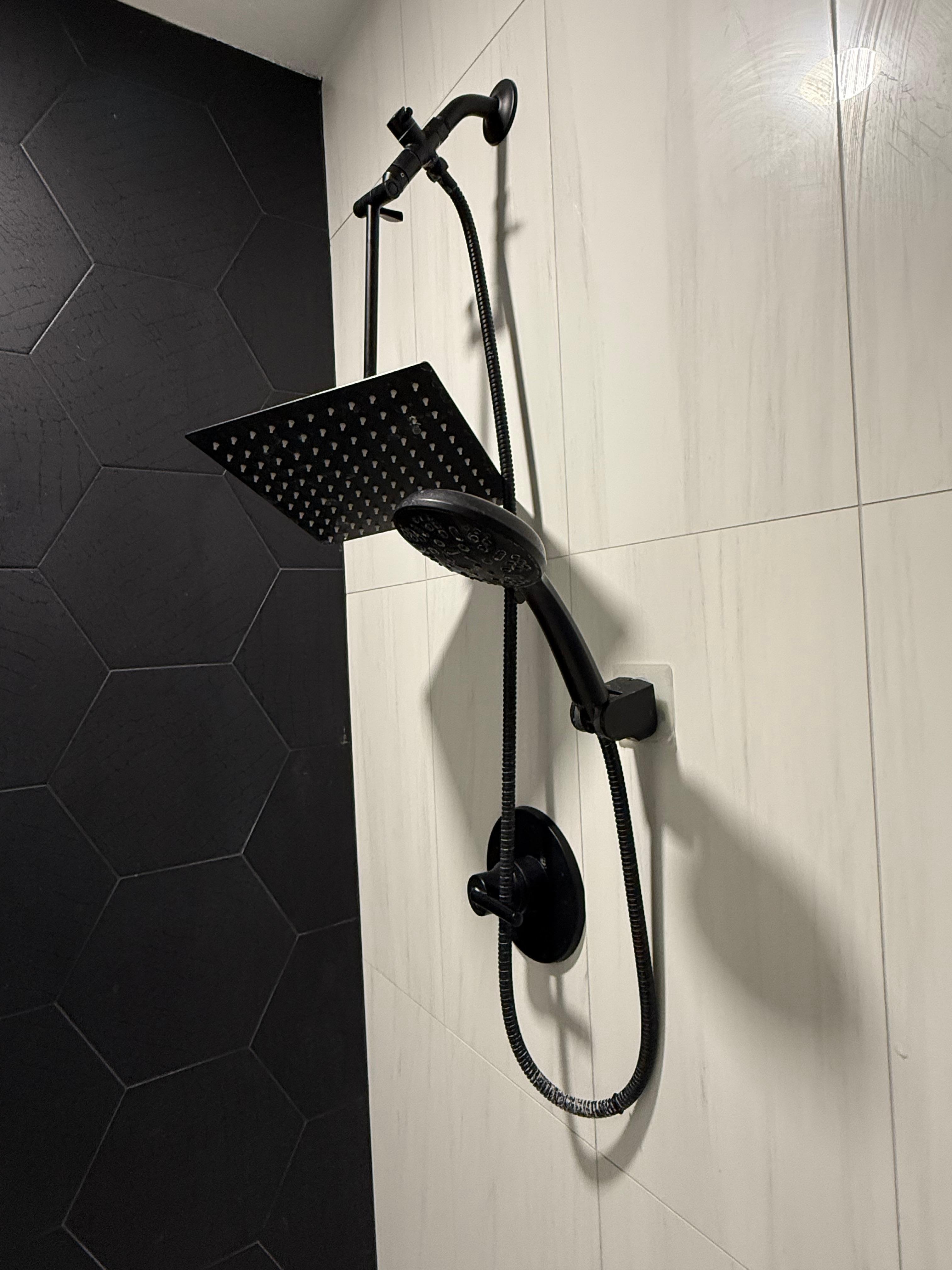 Shower heads not adjustable & not useable despite the bathroom looking to be fairly recently remodeled. 