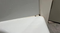 Shower mold near faucet. The floor sagged in the TV area + when you step out of the shower. Probably old water damage that was improperly fixed.