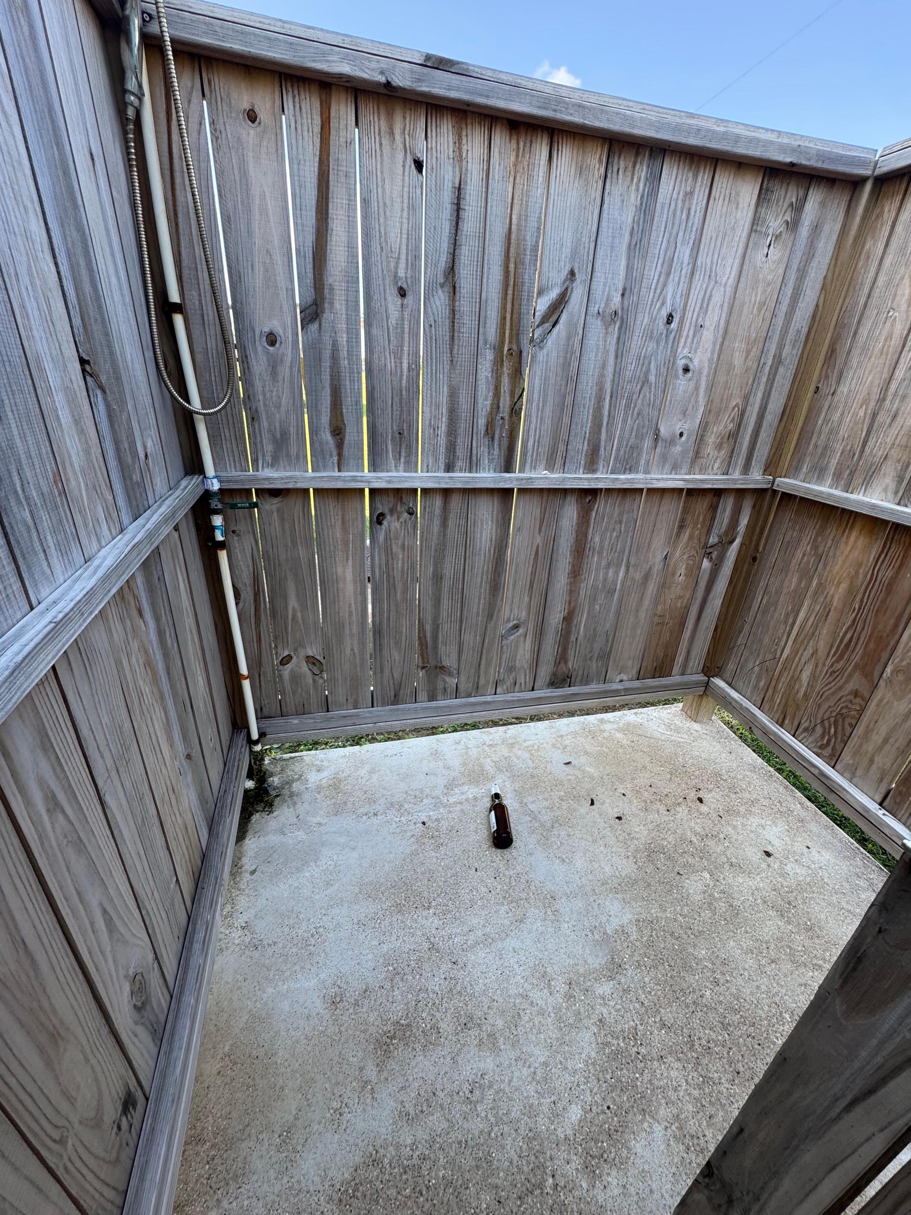 Broken beer bottle in the outside shower. Left behind by previous guest!