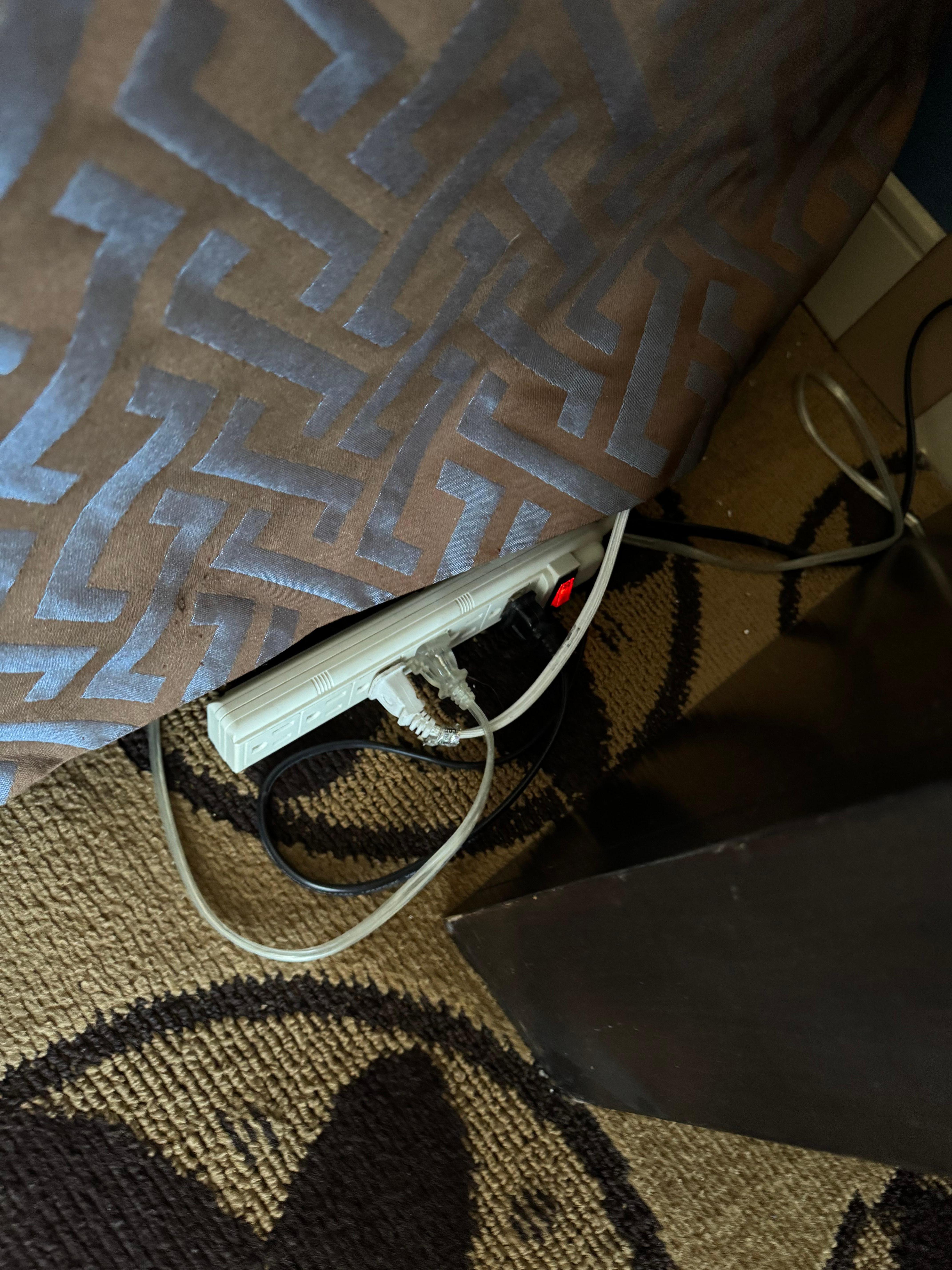 Extension cords on side of bed