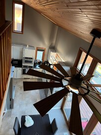 Looking down on kitchen and dining room from loft by widows walk.