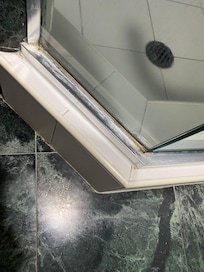 Shower trim was stained and dirty Shower glass was streaky.