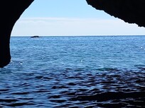 Looking outside from a cave on the sea