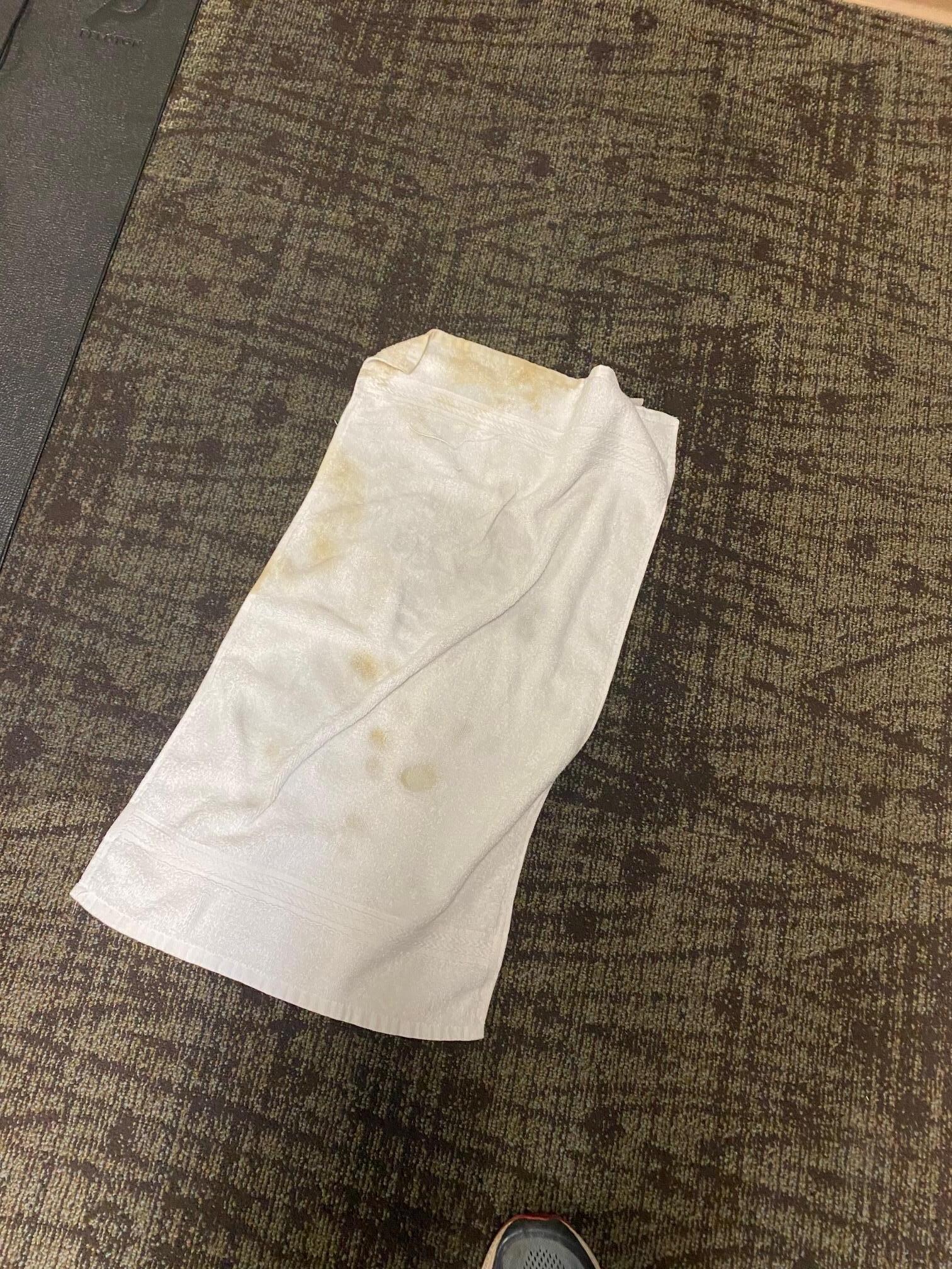 Towell placed on exercise room floor became soaked and stained (rust?).