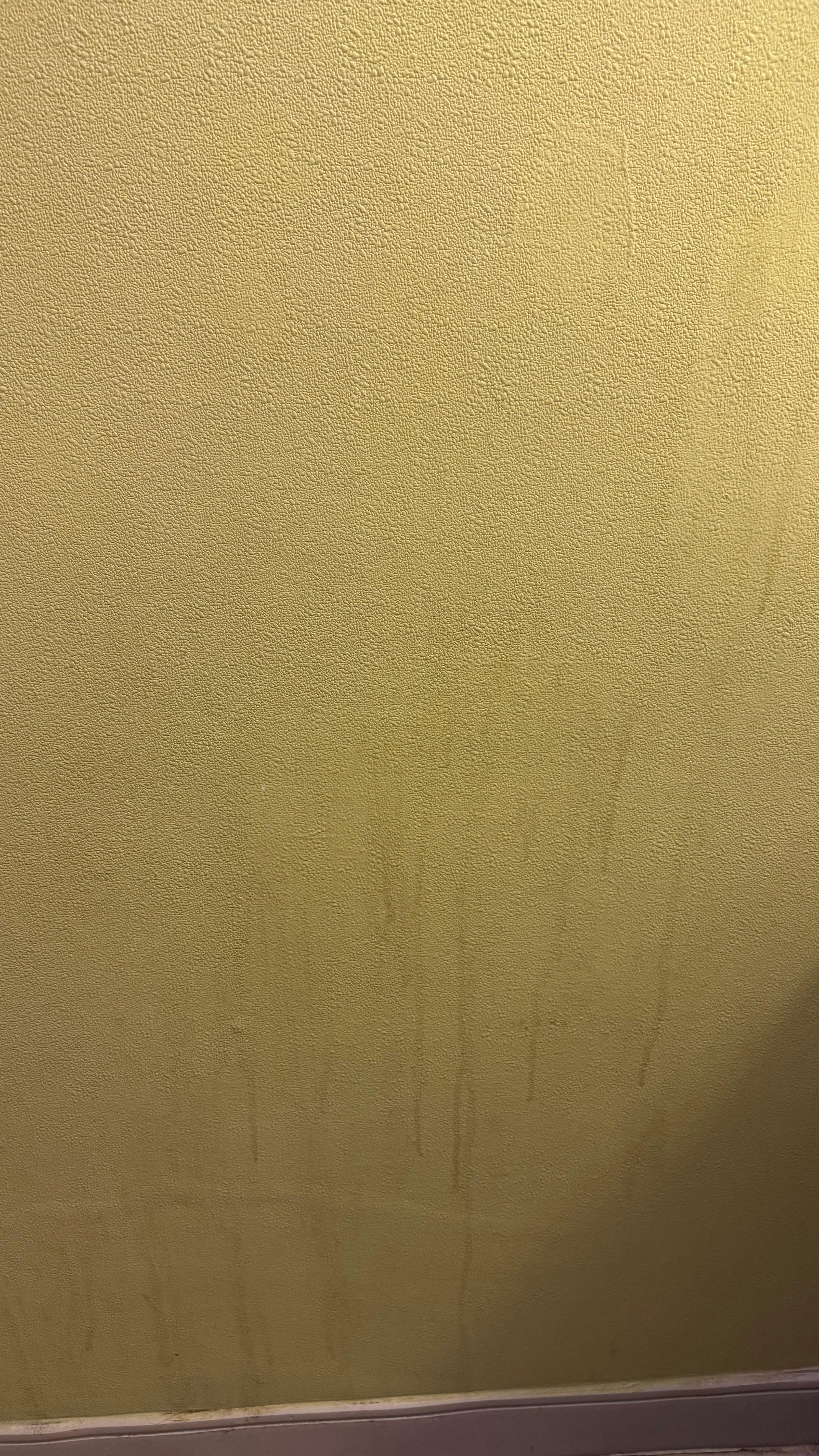 Liquid unknown sticky stains on a different wall -  unsanitary conditions 