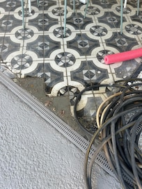 Outdoor patio tile. Dirty, broken . Hose left all week on the patio.