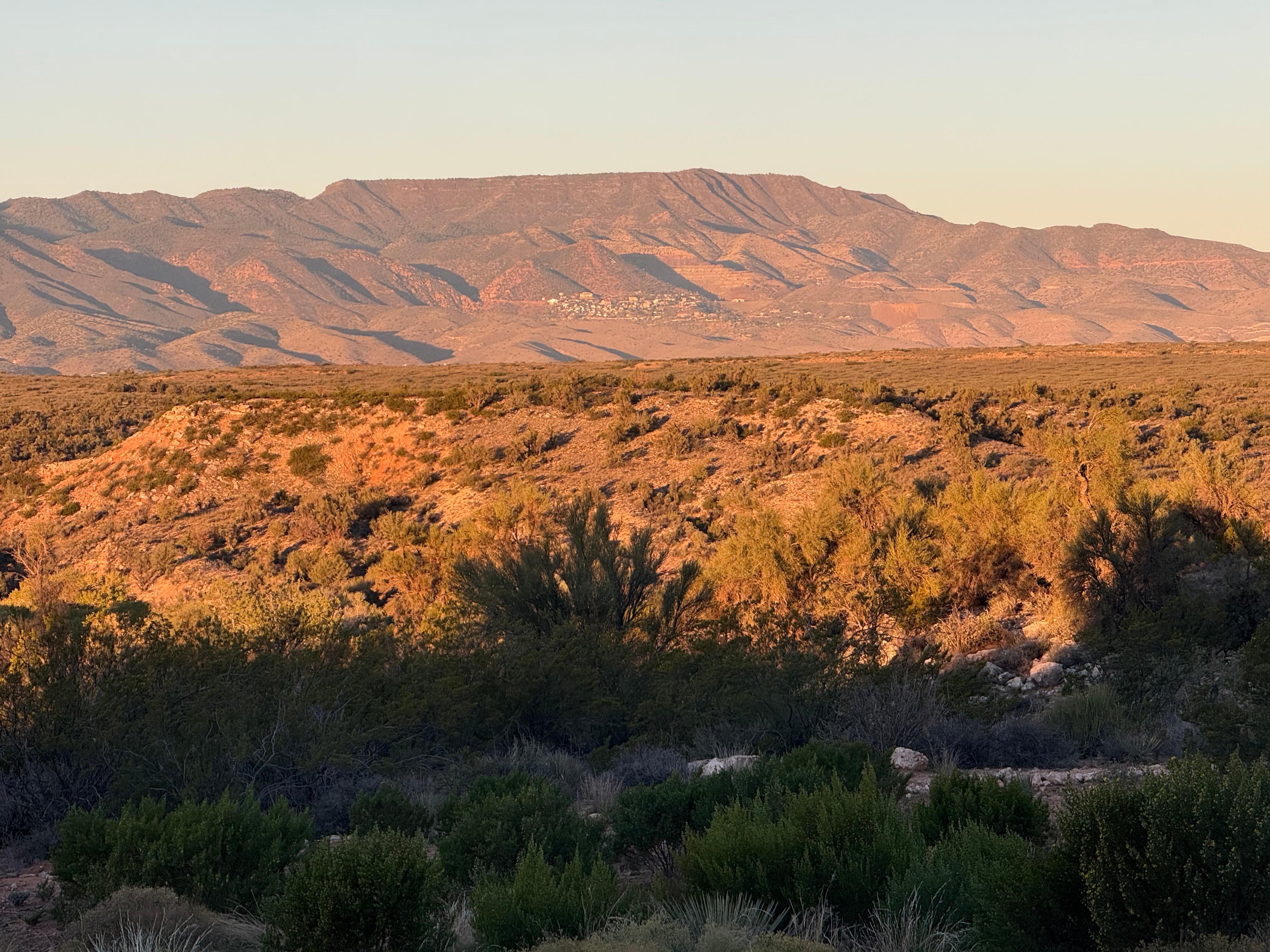 Jerome on mountainside in distance.