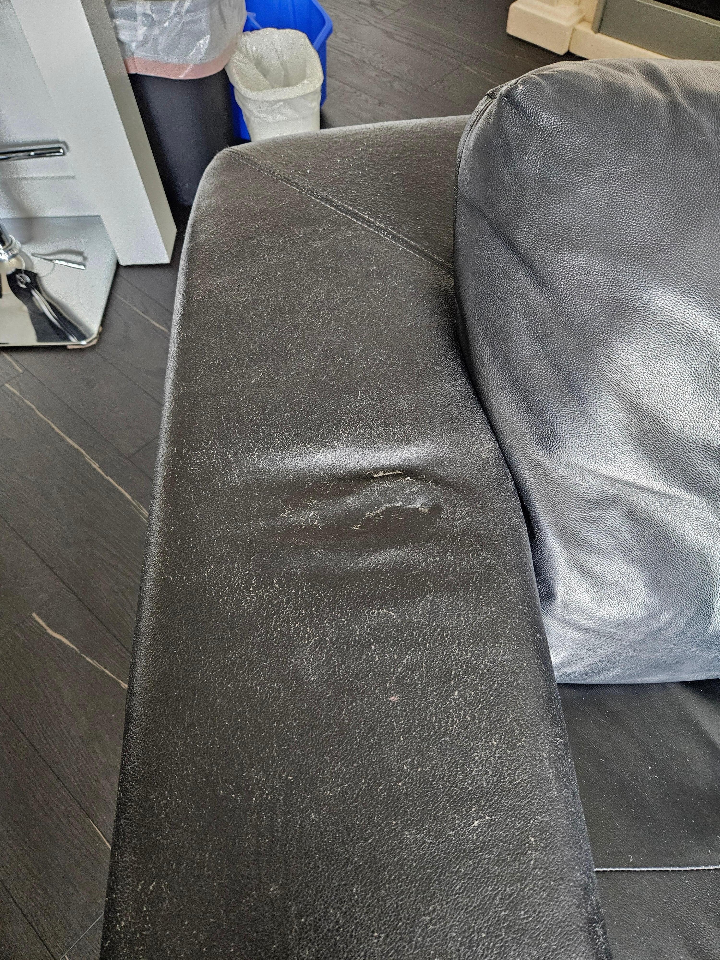 Worn and dented loveseat.