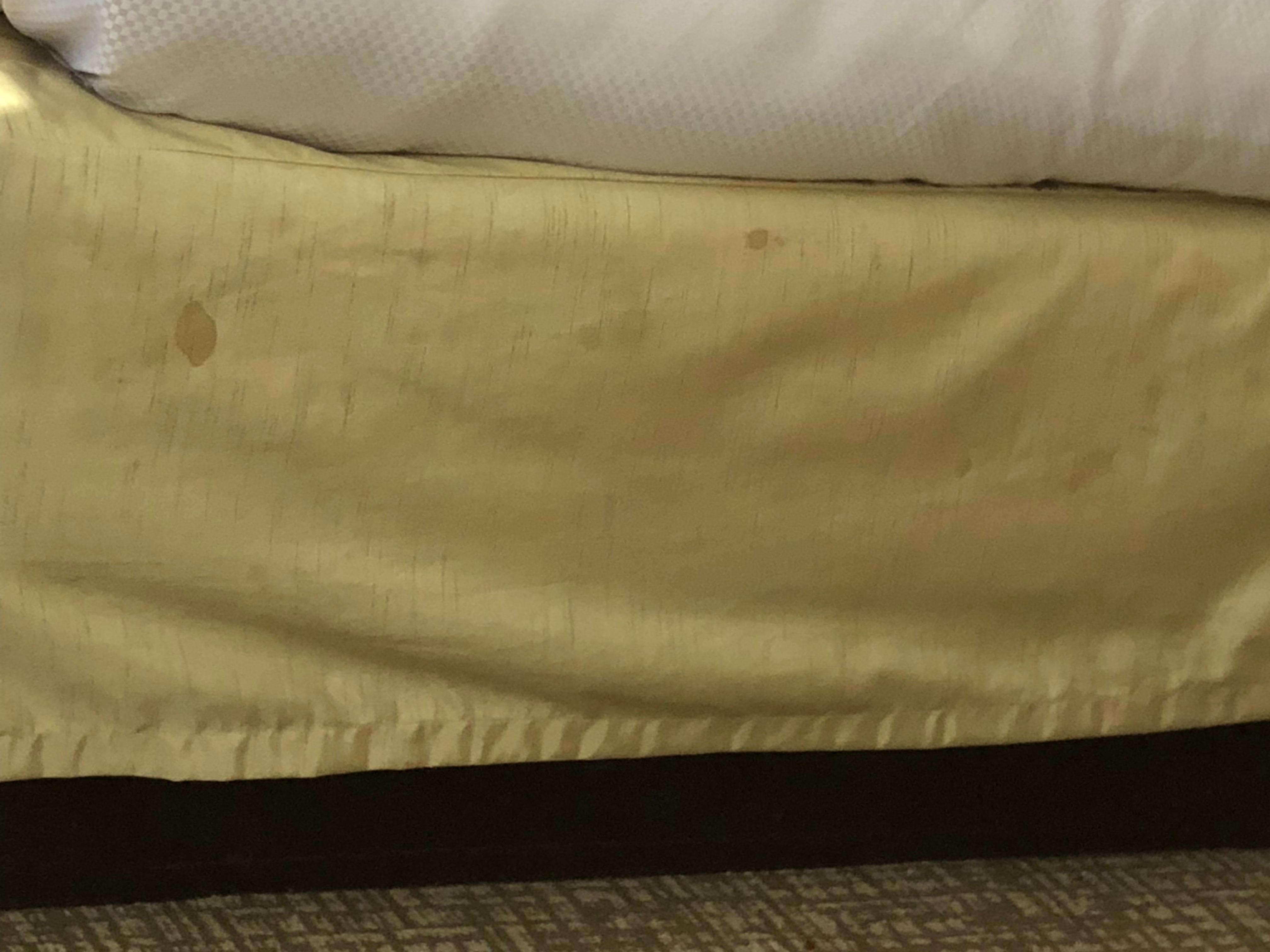 Stained and dirty covering for the base of the bed.