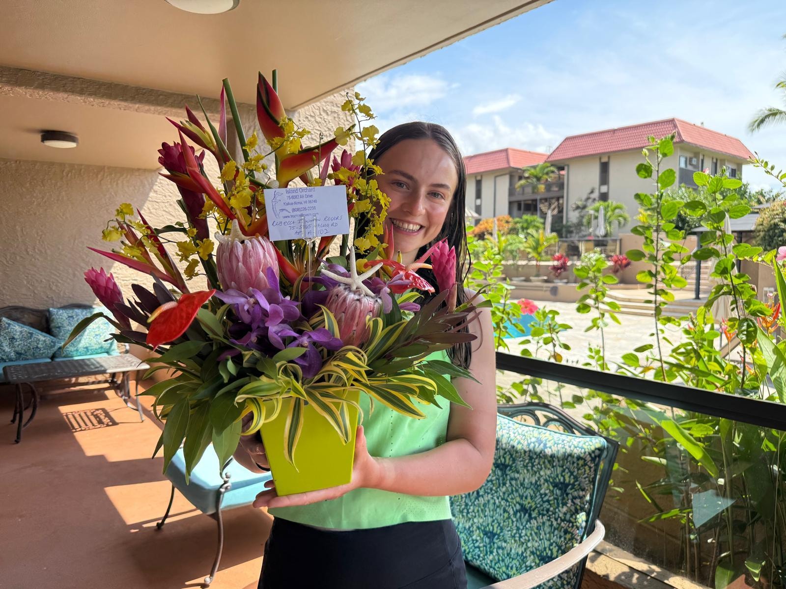 Taken on the lanai, pool view. Flowers for my niece after completing the Ironman