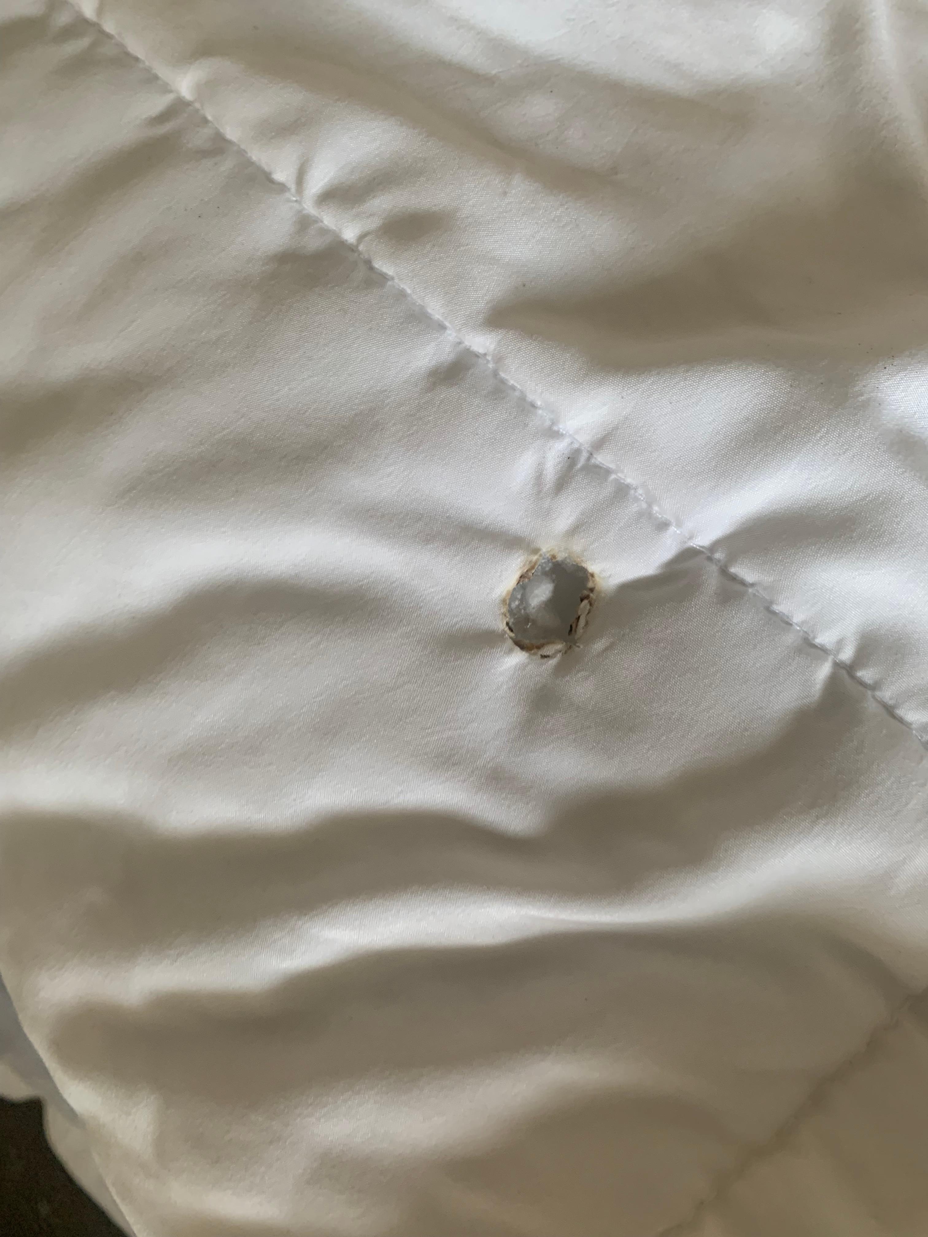Several cigarette burns in bedding 