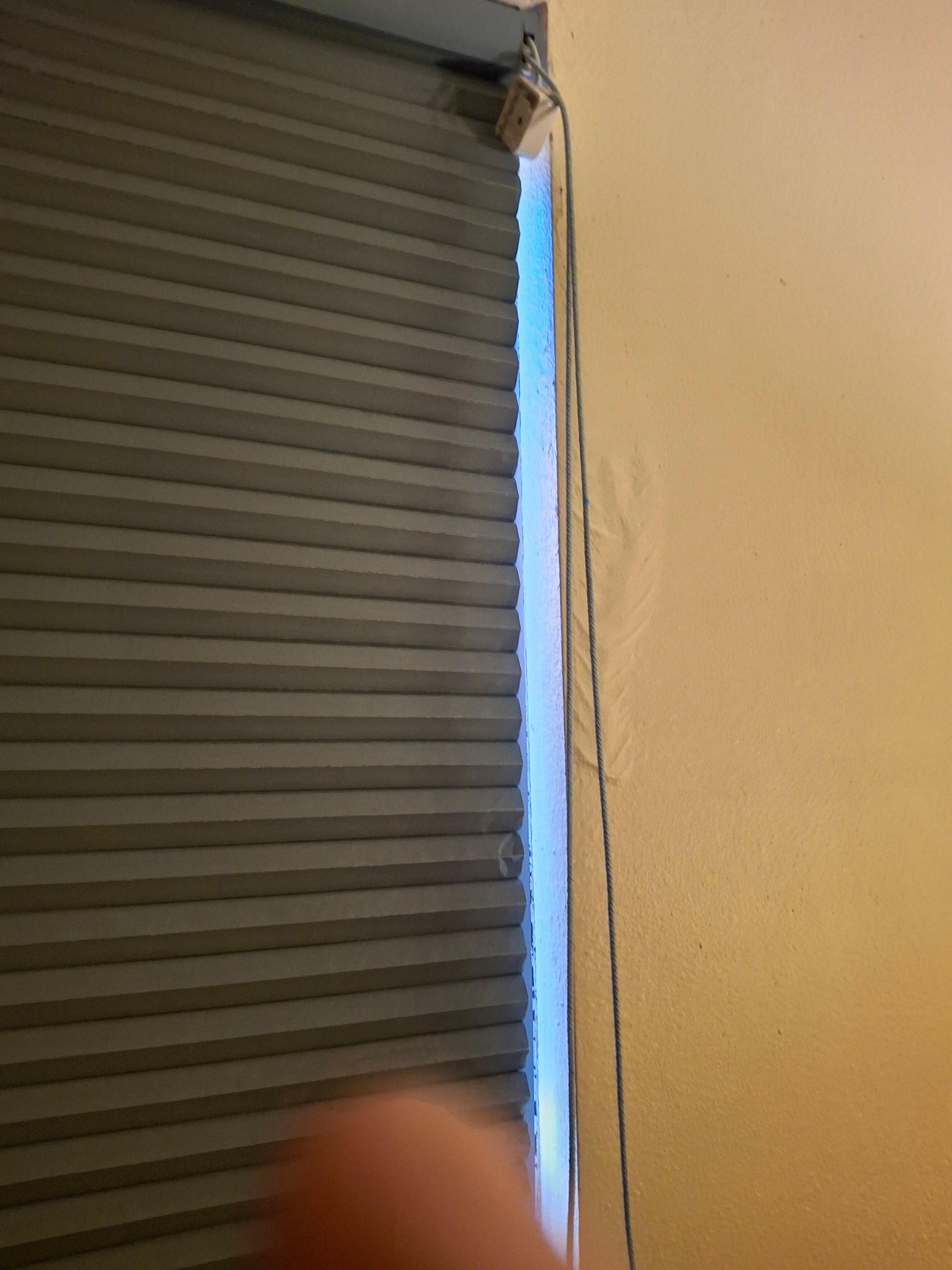 Paper blinds were broken and appeared to be glued shut to the sill. The cord housing was falling off.