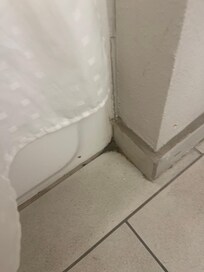 Dirt and grime just piled in the corners of restroom