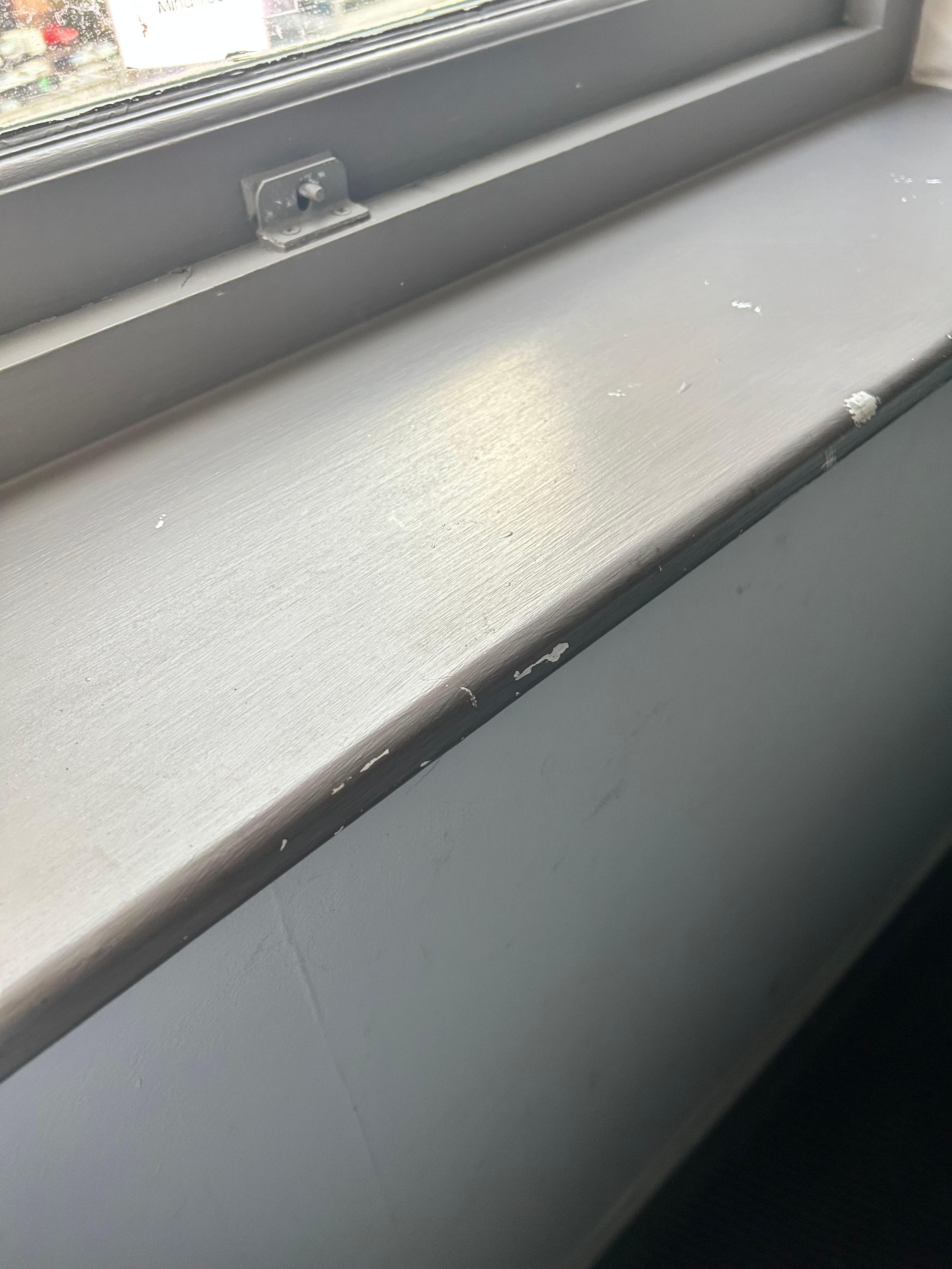 Scuffs and blobs of paint on window sill 