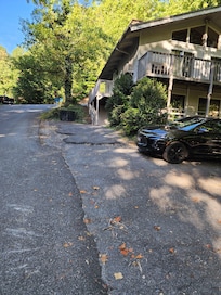 Lower parking where 2 cars can park then the side parking area that is very close to the road