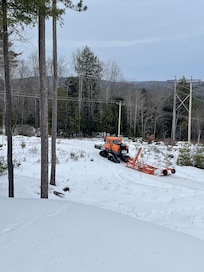 Crew out grooming the snowmobile trails that’s in the backyard of the A-frame