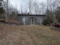 The front of the cabin, with the fire pit off to the left