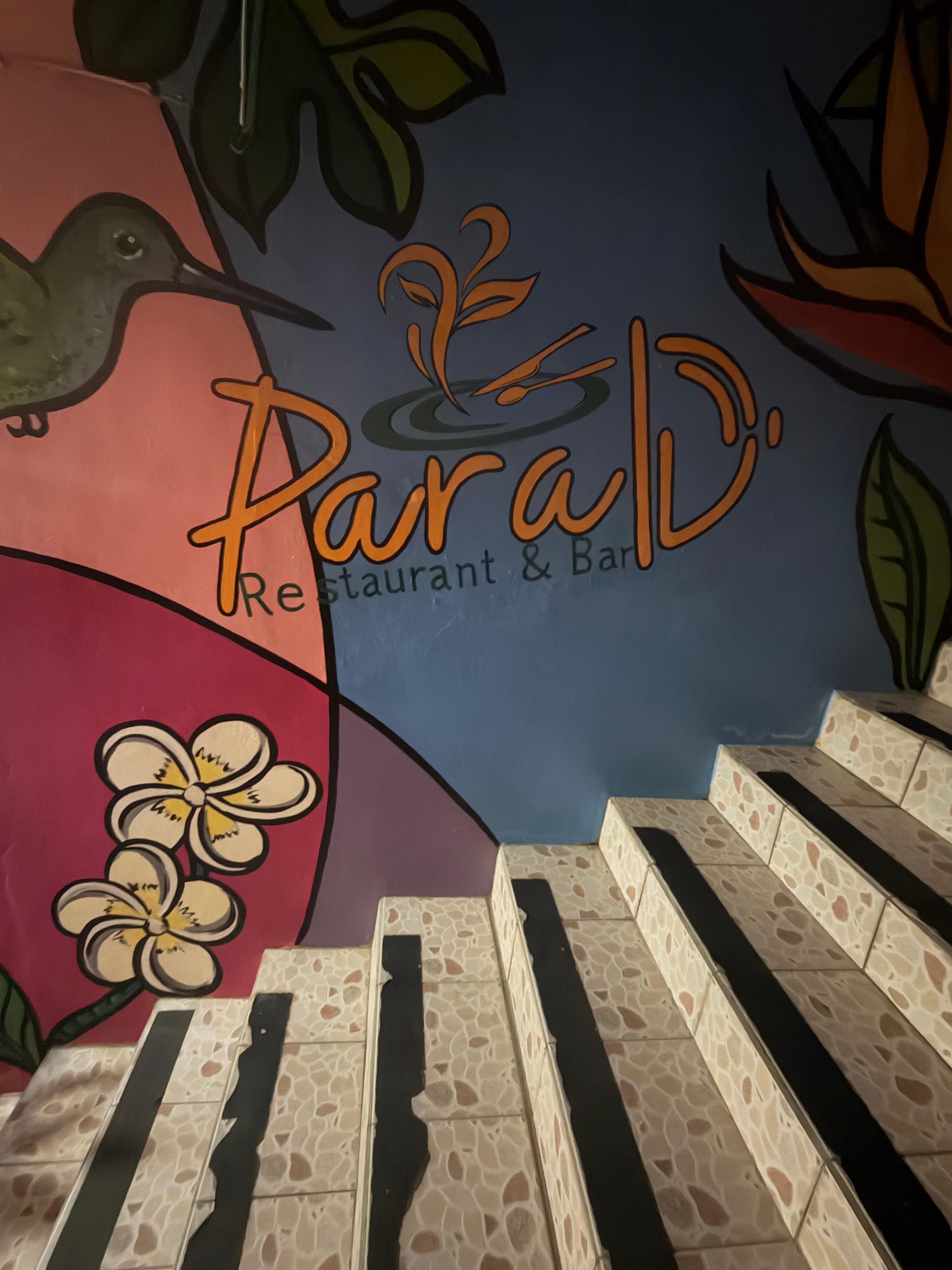 A picture of the name of the restaurant downstairs from the hotel. 