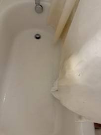 Yellow shower curtain with someone’s blood on it