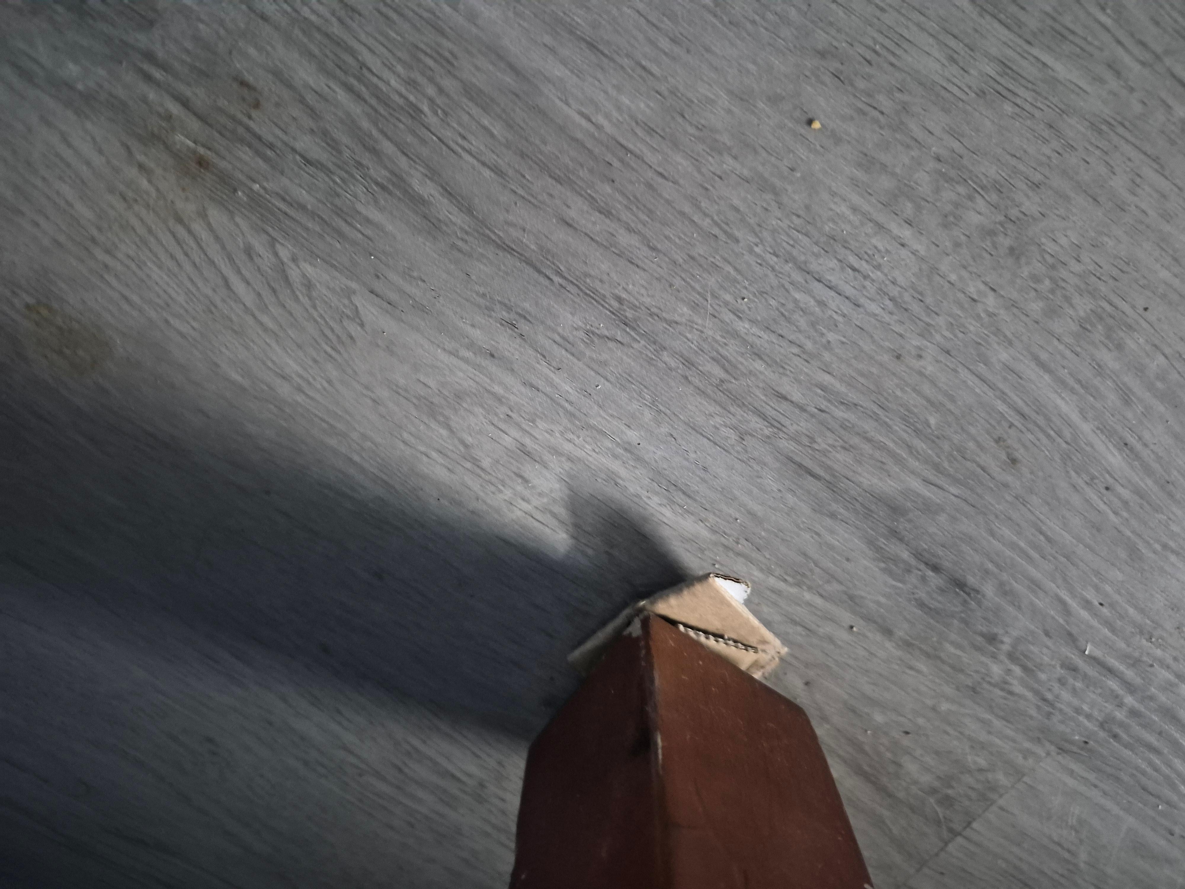 Cardboard under dresser leg.