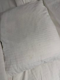 Dirty pillow case with hair from the previous guest