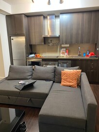 Kitchen area and living room, not as depicted in the listing.