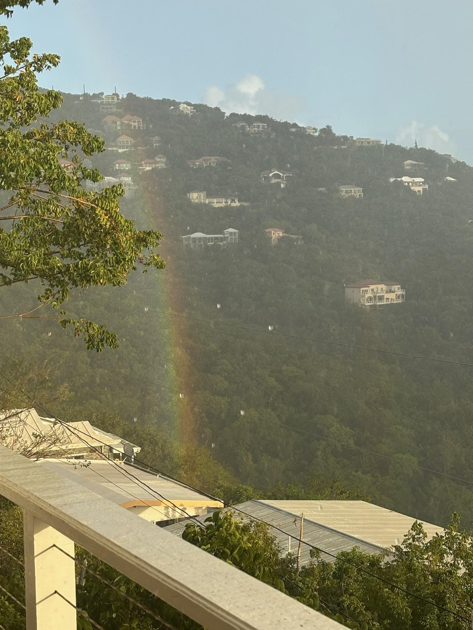 Rainbow beside the balcony during one of the gentle island rains.