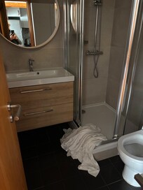 Ample bathroom with drawer space, shower & toilet