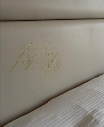Marks on the headboard of the bed.